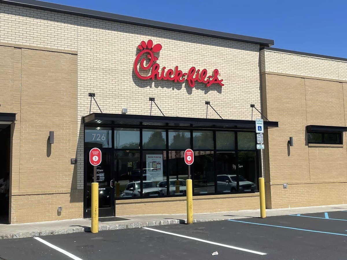 A Chick-Fil-A restaurant in a parking lot.