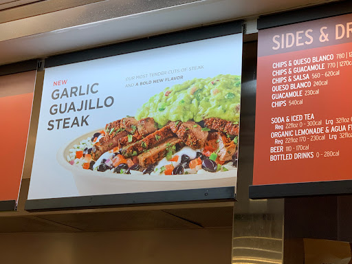 Mcdonald's menu board featuring garlic guacamole steak with chipotle prices.