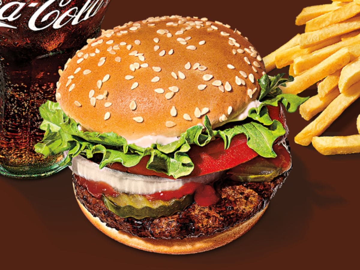 A protein-packed burger with a side of fries and a refreshing coca cola.