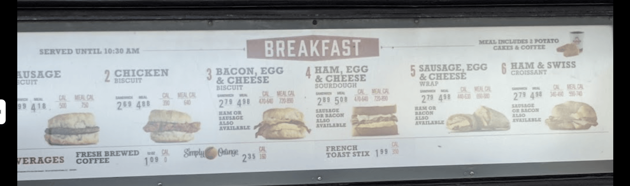 A Arby's breakfast menu is displayed on a street sign.