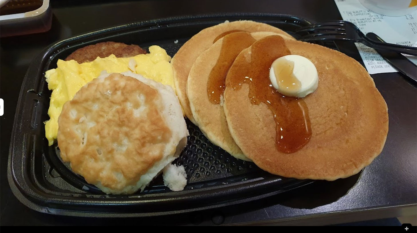 Pancakes and biscuits on a tray.