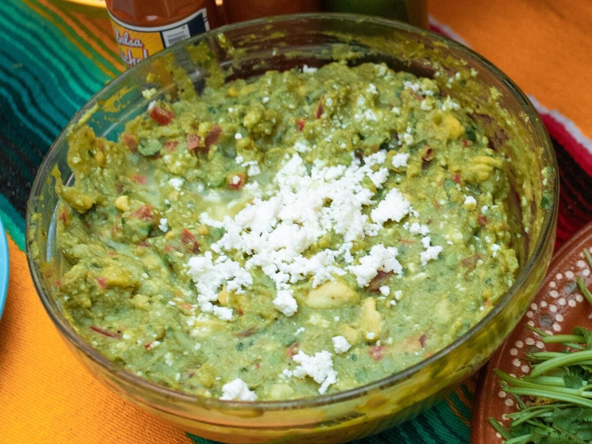 A bowl of gluten-free guacamole on a table.