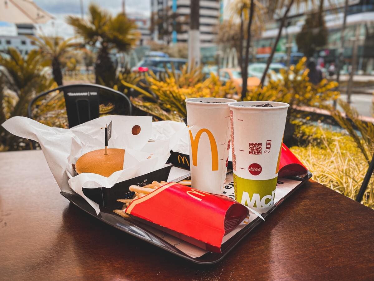 Two mcdonald's drinks and fries on a tray for the 2 for 5 deal.