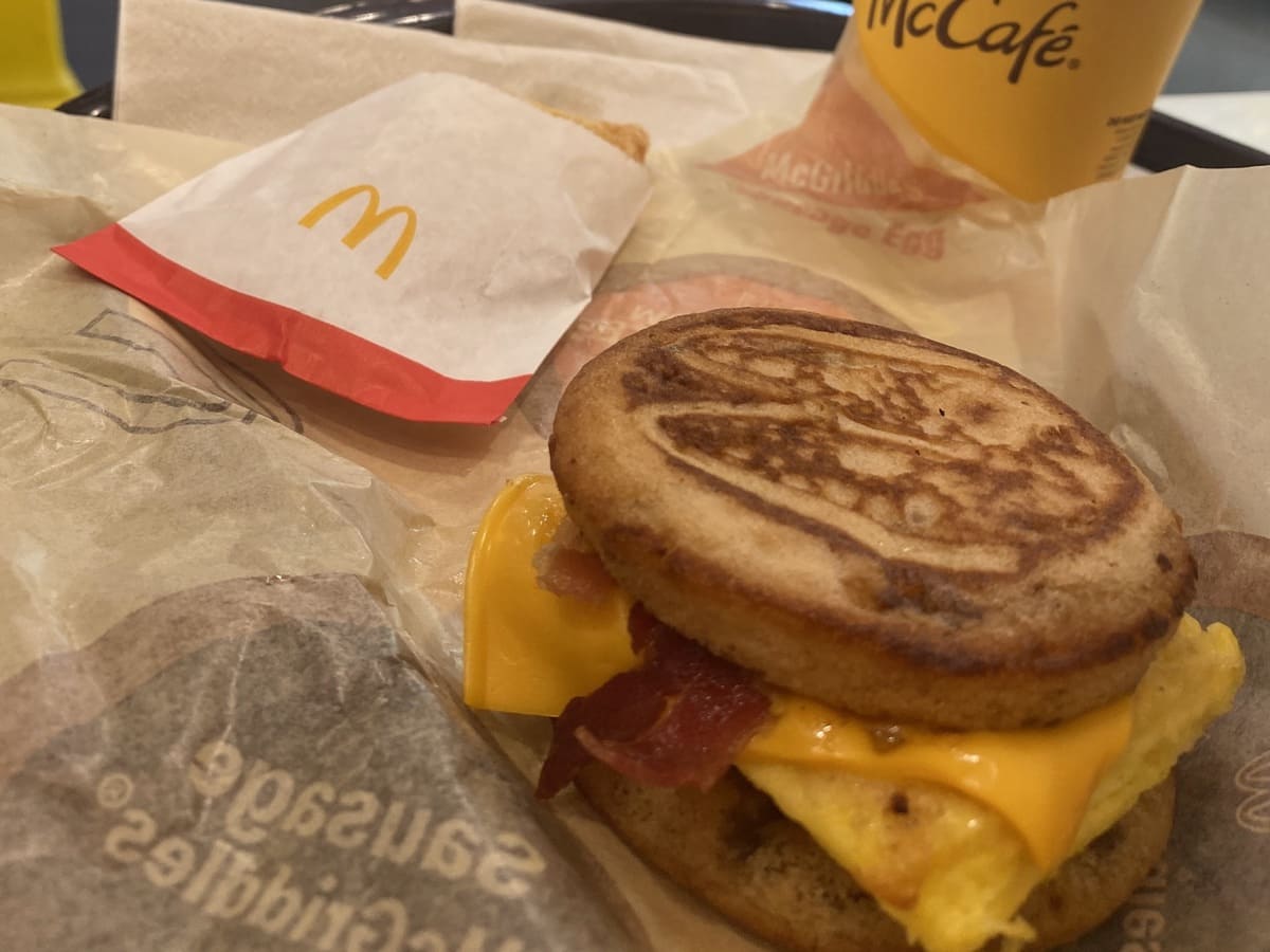 A McDonald's breakfast sandwich with bacon and eggs served during morning hours.