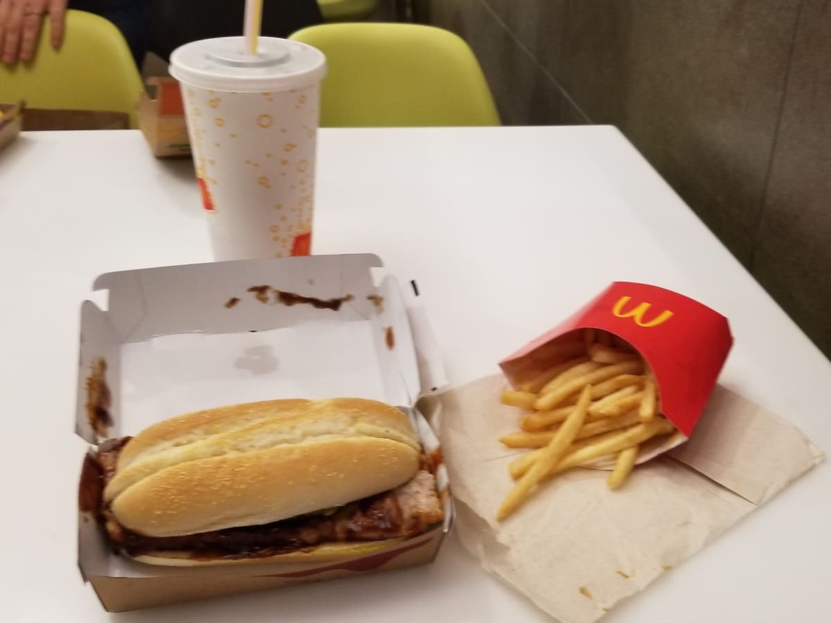 A McDonald's lunch spread with a sandwich and fries on a table.