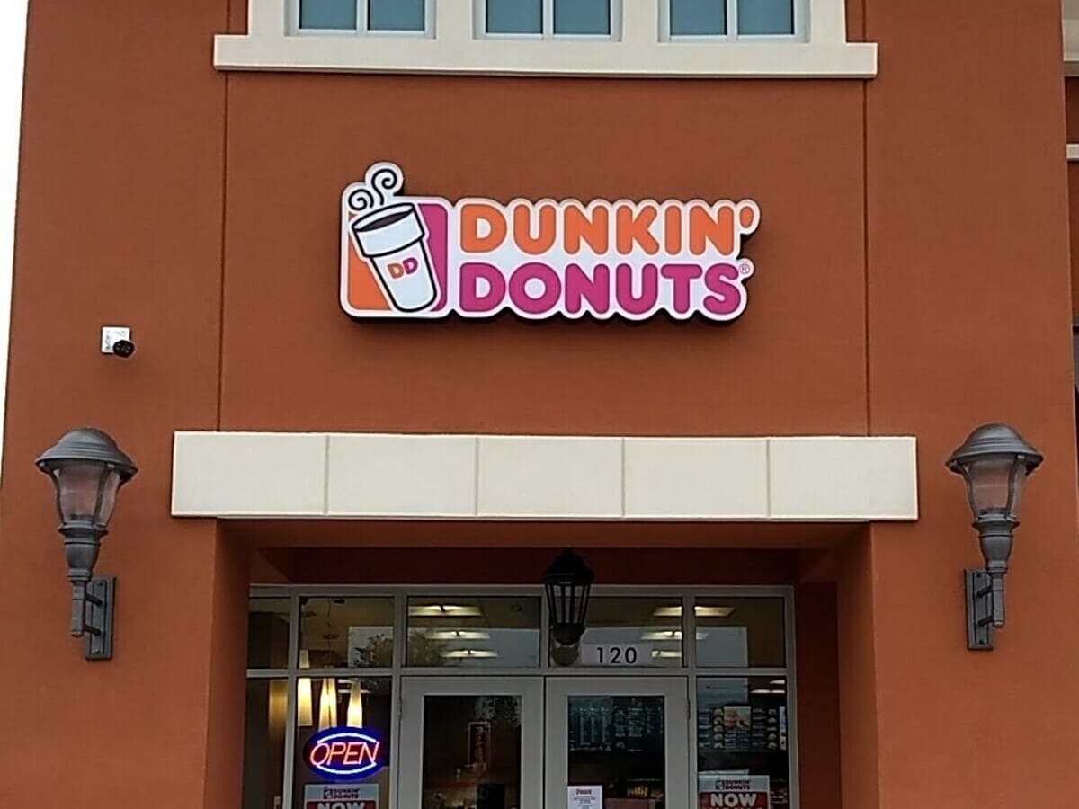 A heart healthy Dunkin Donuts store with a sign on the front door.