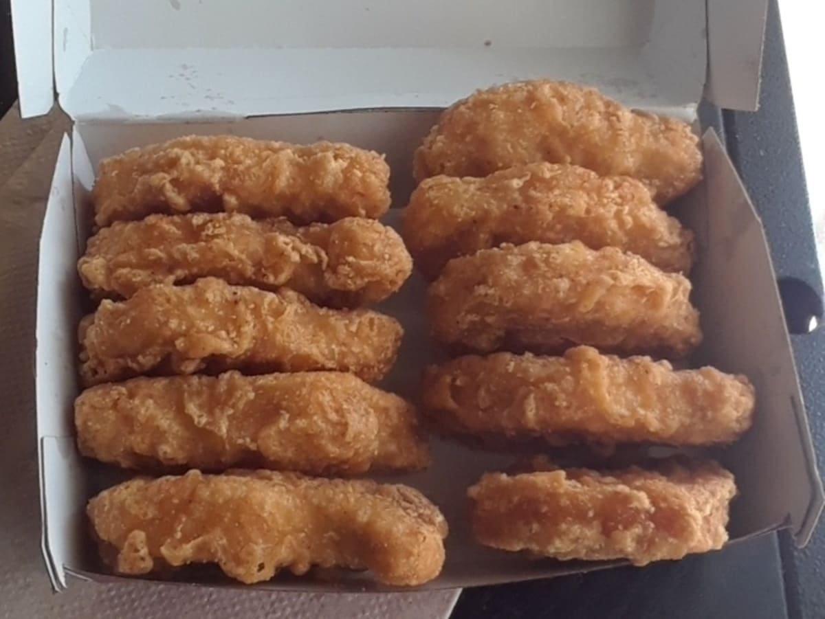 Chicken nuggets in a box on a table.