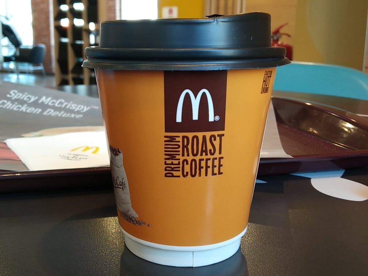 A mcdonald's coffee cup on a table.