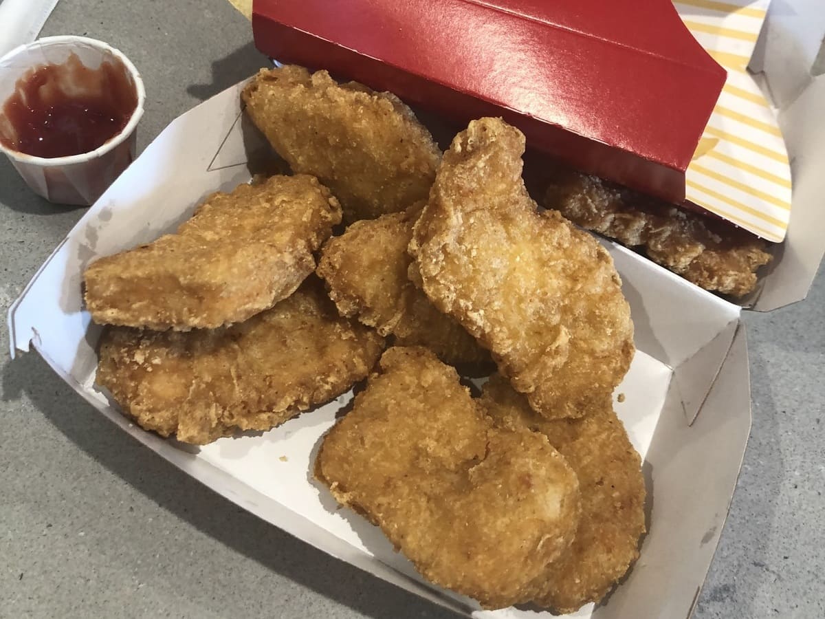 Mcdonald's chicken nuggets in a box with ketchup.