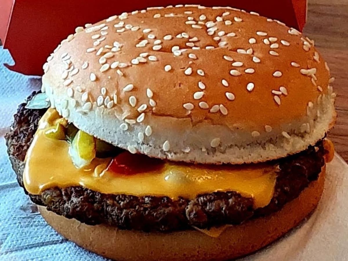 A mcdonald's burger is sitting on top of a box.