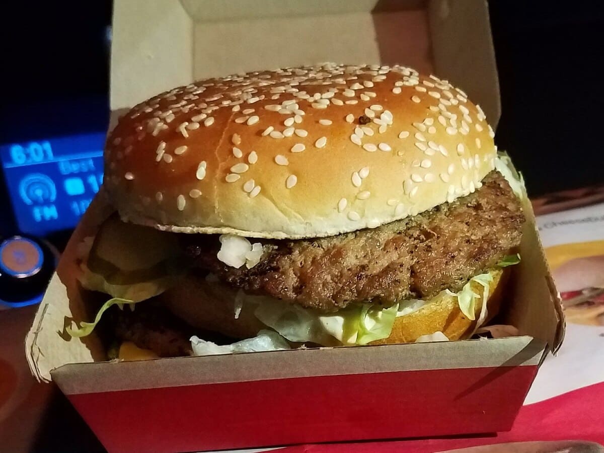A mcdonald's burger in a cardboard box.